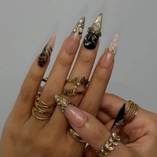 Noir Opulence - black and gold chrome press on nails by LilyNailsArt featuring 3D gold floral bows, lace overlays, leopard print accent, pearls, and crystal embellishments
