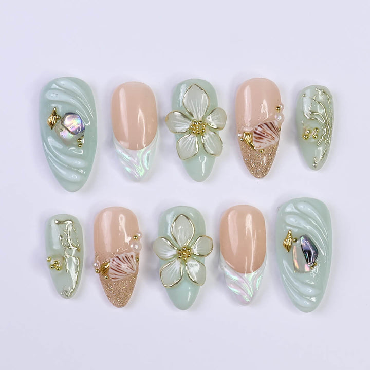 3D seafoam press-on nails with pearl flower accents, gold seashells, and iridescent wave textures — handmade luxury nail art, reusable and custom-sized false nails in a soft pastel green and nude colorway — perfect for beach weddings, summer travel, or romantic coastal looks.