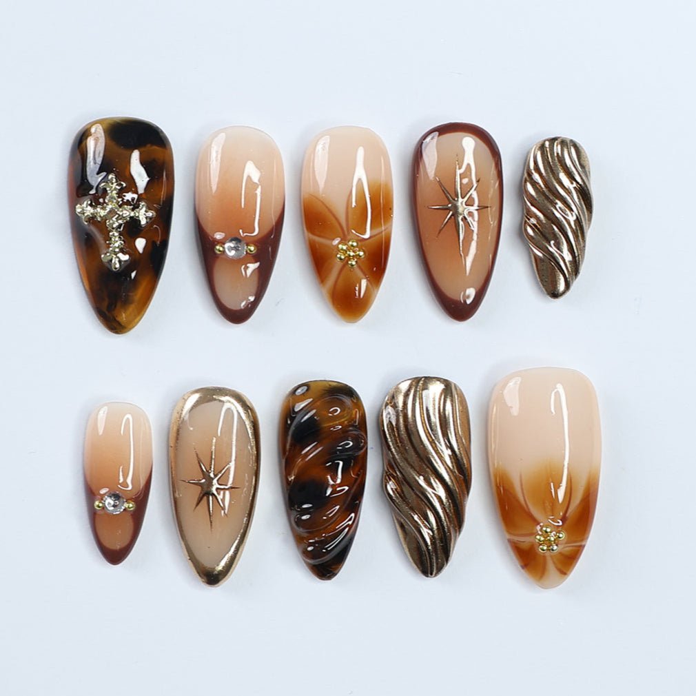 Rich, sultry, and effortlessly chic. Tortoise shell, gold accents, and silky caramel hues come together for the ultimate luxury nail set. The perfect mix of soft glam and bold elegance, these nails add an expensive touch to every outfit. Whether you're sipping coffee in a sleek blazer or dressing up for a night out, this set is your new obsession. 
