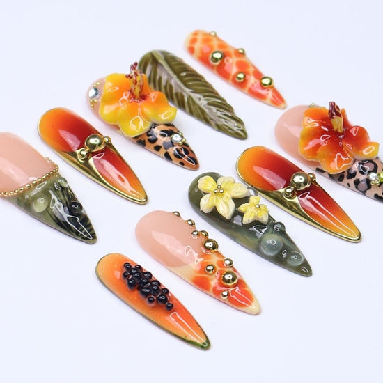 3D tropical press on nails with sunset ombré, hibiscus flowers, leopard print, and jungle leaves in orange and olive tones — summer vacation nails, tropical handmade nail art, fake nails, false nails, pressons — perfect for beach getaways or statement summer looks.