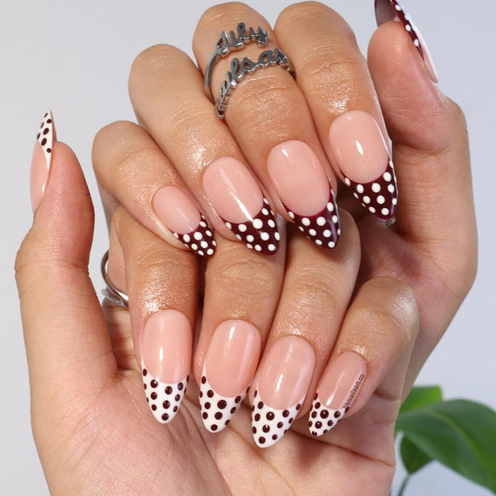 Brown and white polka dot press-on nails with French tip design, medium almond shape — handmade custom fake nails, perfect for holiday style or everyday wear