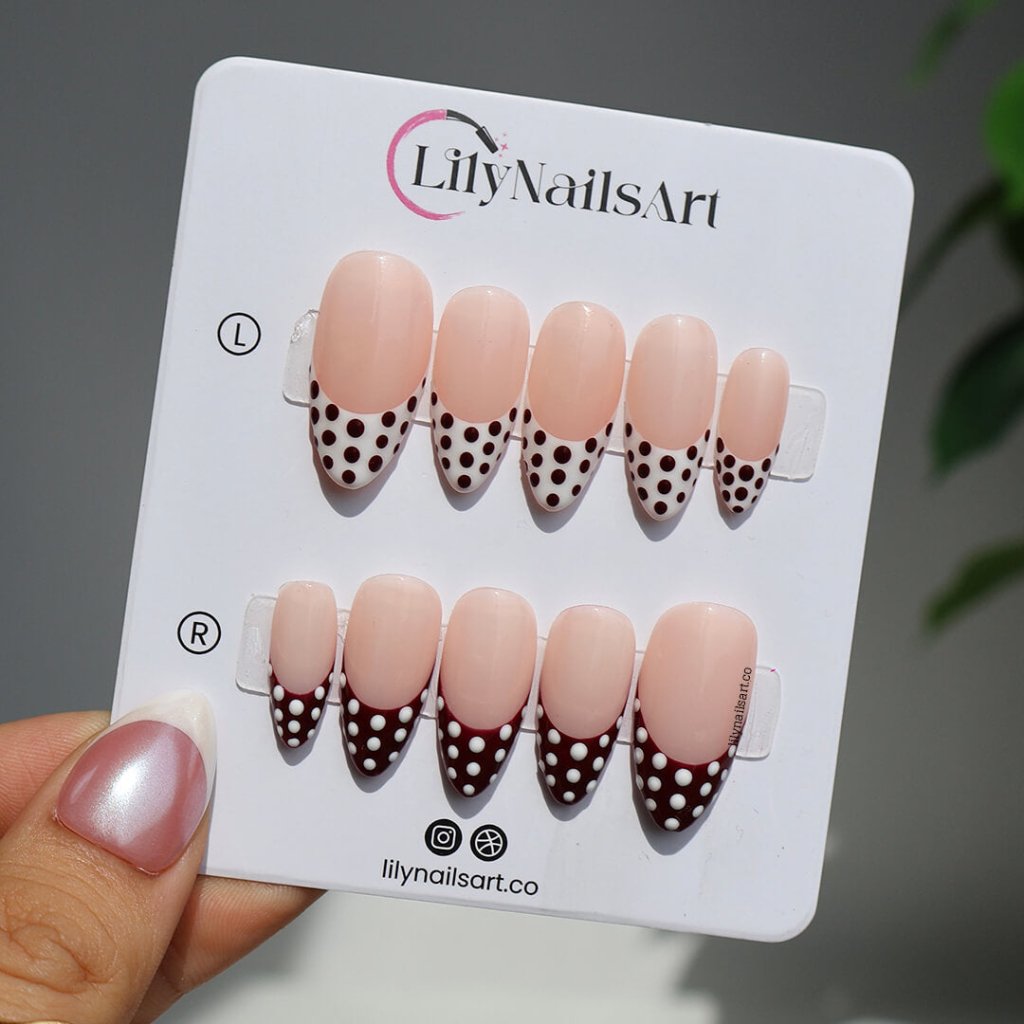 Brown and white polka dot press-on nails with French tip design, medium almond shape — handmade custom fake nails, perfect for holiday style or everyday wear
