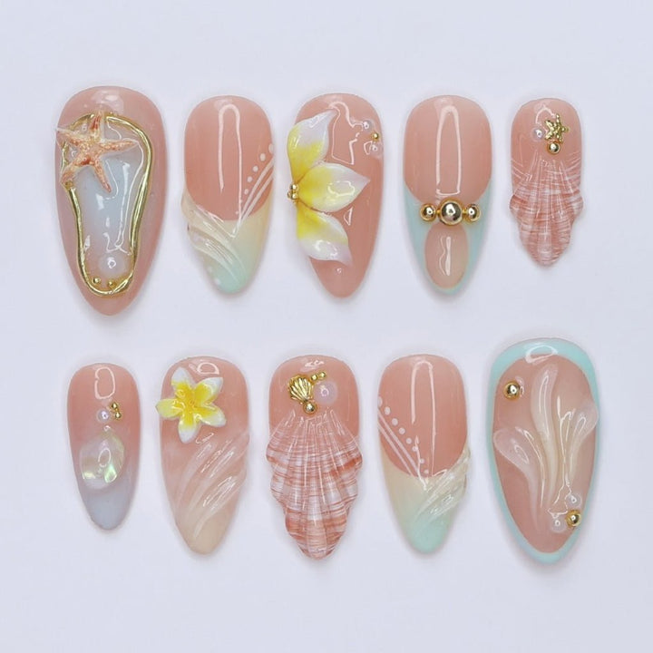 3D beach press on nails with seashells, starfish, plumeria flowers, and soft pastel waves, featuring gold charms, pearl details, and glossy ocean-inspired accents — summer vacation nails, ocean press on nails, custom handmade nail art, fake nails, false nails, pressons — perfect for tropical getaways, beach weddings, or gifting for her.