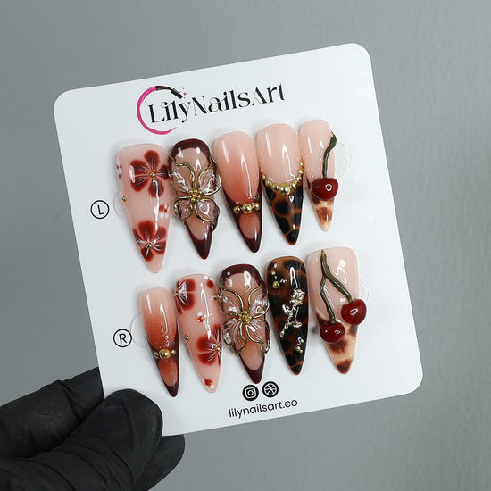 Handmade Press-On Nails with deep cherry tones, 3D floral accents, gold details, and glossy finishes. Perfect for holidays, birthdays, or as a luxurious gift for her