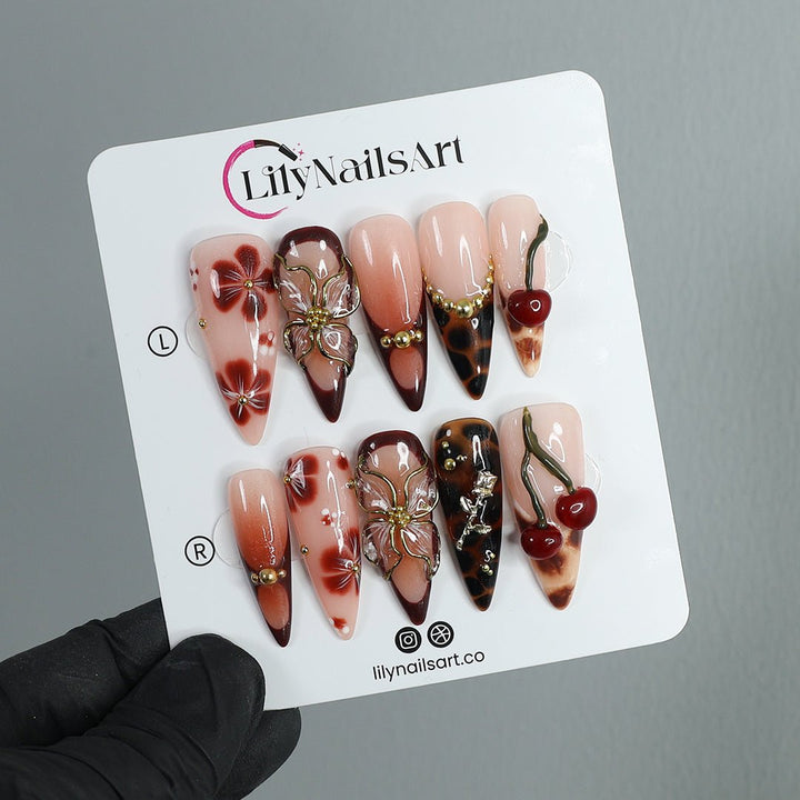 Handmade Press-On Nails with deep cherry tones, 3D floral accents, gold details, and glossy finishes. Perfect for holidays, birthdays, or as a luxurious gift for her