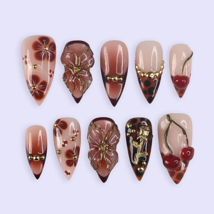 Medium stiletto press on nails with red cherry accents, 3D floral designs, tortoiseshell tips, and gold embellishments — luxury handmade false nails for date nights, self-expression, or gifting. Custom press on nails, reusable nail art, fake nails for beauty lovers.