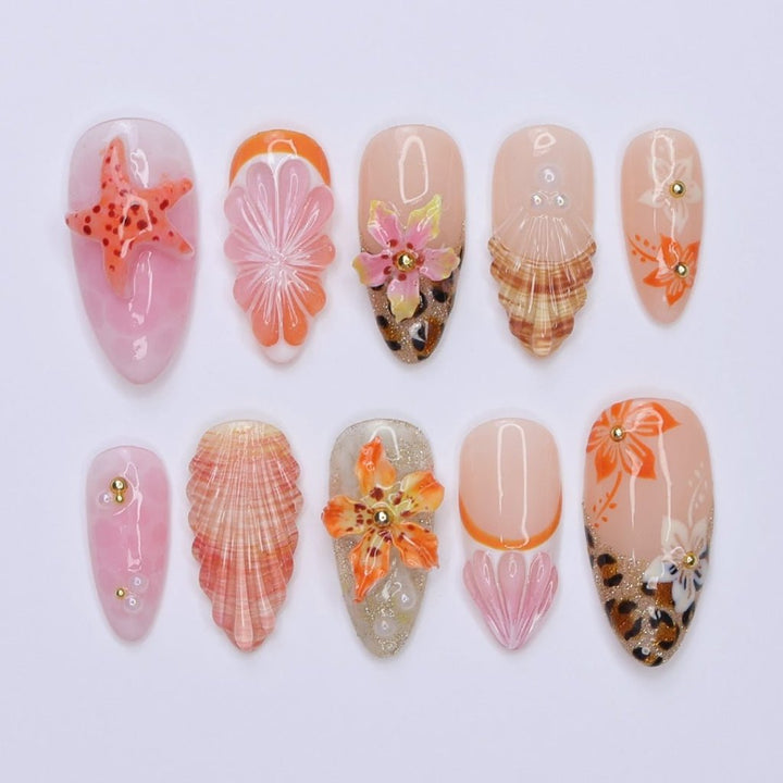 3D beach-themed summer press on nails with starfish, seashells, leopard print, and tropical flower accents, featuring soft pink and coral tones, gold glitter, and sculpted sea elements — summer vacation nails, ocean press on nails, custom handmade nail art, fake nails, false nails, pressons — perfect for tropical getaways, cruises, or summer gifting.