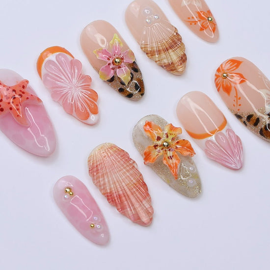 3D beach-themed summer press on nails with starfish, seashells, leopard print, and tropical flower accents, featuring soft pink and coral tones, gold glitter, and sculpted sea elements — summer vacation nails, ocean press on nails, custom handmade nail art, fake nails, false nails, pressons — perfect for tropical getaways, cruises, or summer gifting.

