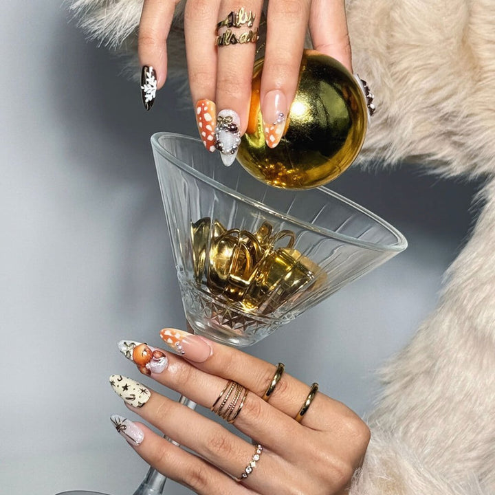 3D holiday press on nails in nude, caramel, and white with reindeer art, candy cane swirls, Christmas tree charms, metallic gold details — luxury handmade Christmas nails, reusable false nails, festive nail art — perfect for winter parties, holiday gifts, or cozy glam nights.
