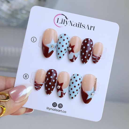 Handmade almond press on nails featuring a playful mix of burgundy polka dots, nude base with burgundy geometric tips, silver bead accents, and abstract line art. Retro-inspired, perfect for a bold and stylish look.