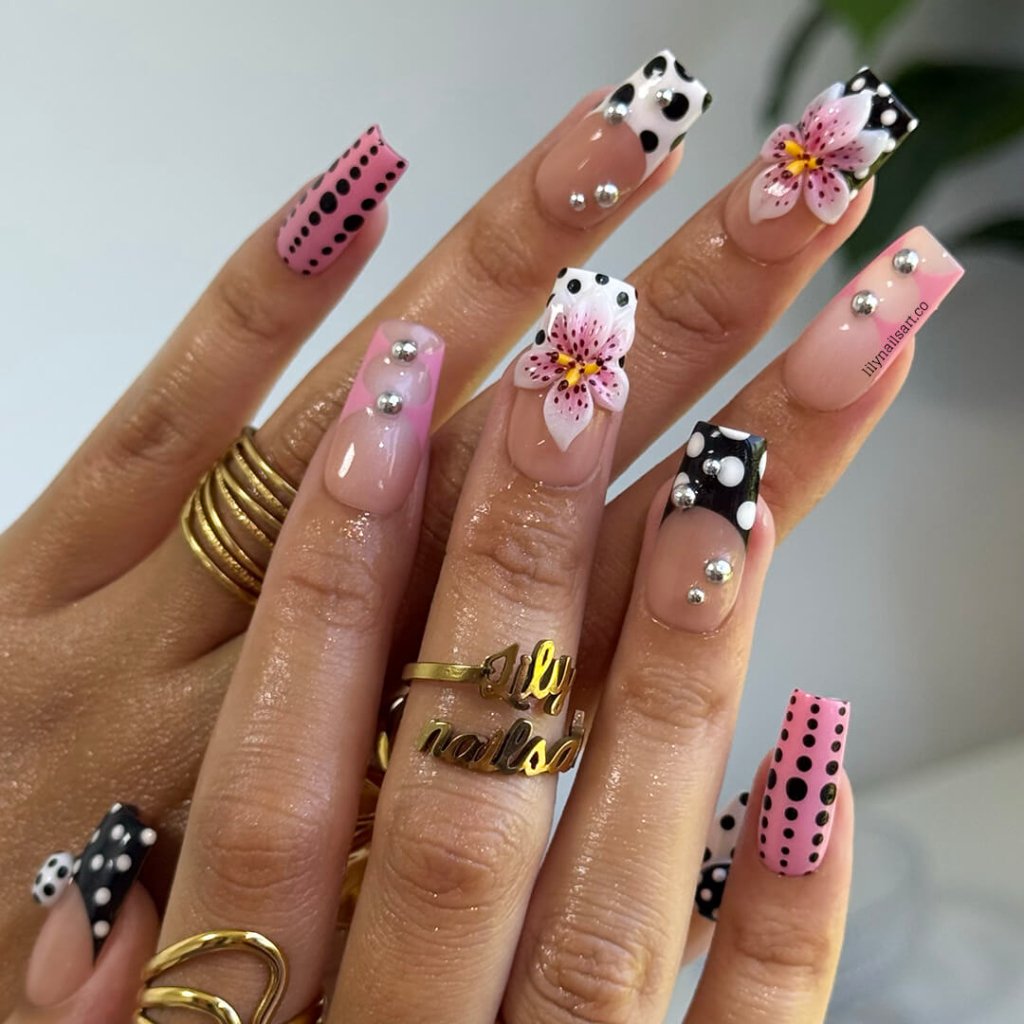 Handmade Medium Square press on nails with a playful mix of pink, black, and white polka dots, 3D pink floral accents, silver bead embellishments, and geometric French tip designs. A bold and feminine style perfect for statement looks.