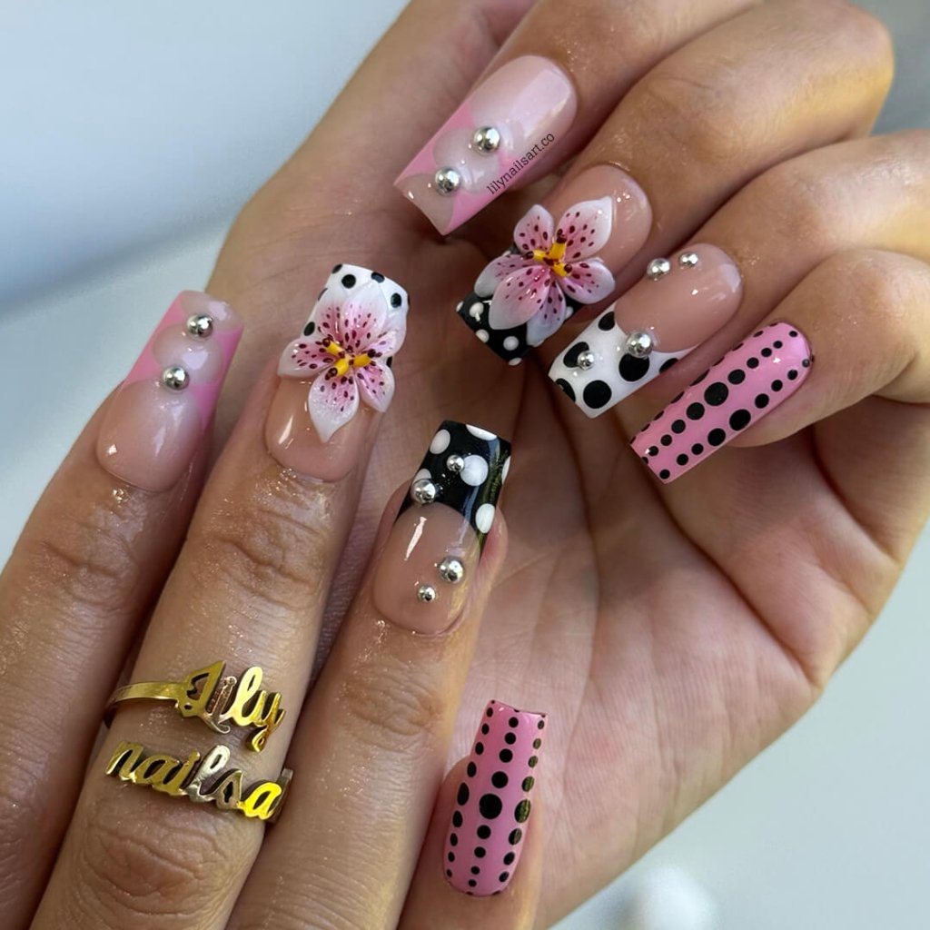 Handmade Medium Square press on nails with a playful mix of pink, black, and white polka dots, 3D pink floral accents, silver bead embellishments, and geometric French tip designs. A bold and feminine style perfect for statement looks.