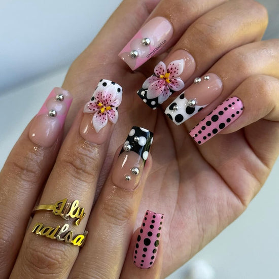 Handmade Medium Square press on nails with a playful mix of pink, black, and white polka dots, 3D pink floral accents, silver bead embellishments, and geometric French tip designs. A bold and feminine style perfect for statement looks.