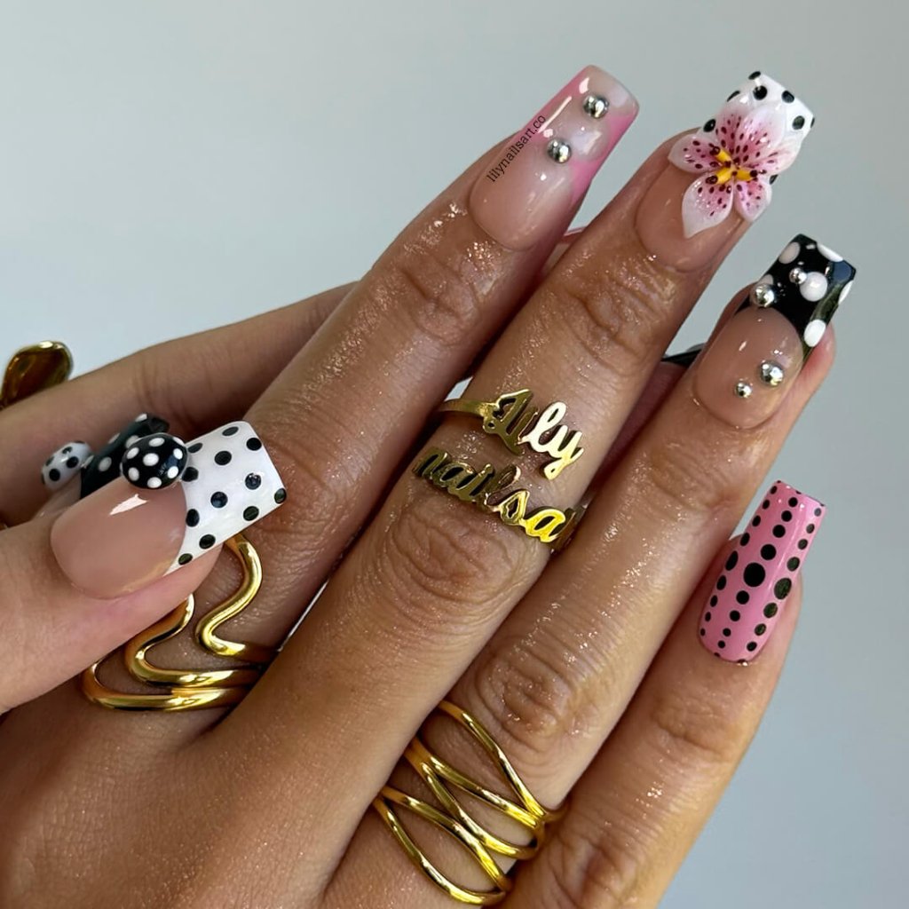 Handmade Medium Square press on nails with a playful mix of pink, black, and white polka dots, 3D pink floral accents, silver bead embellishments, and geometric French tip designs. A bold and feminine style perfect for statement looks.