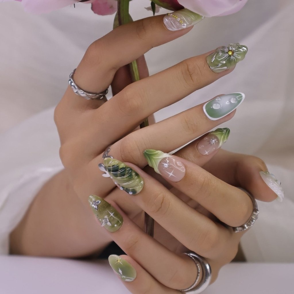 Awaken the spirit of the forest with Sylvara, a graceful press-on nail set woven with misty greens, sparkling silver details, and sculpted 3D florals. Blending soft gradients, leafy textures, and dewdrop-like accents, Sylvara captures the quiet magic of nature’s hidden groves. 🌿