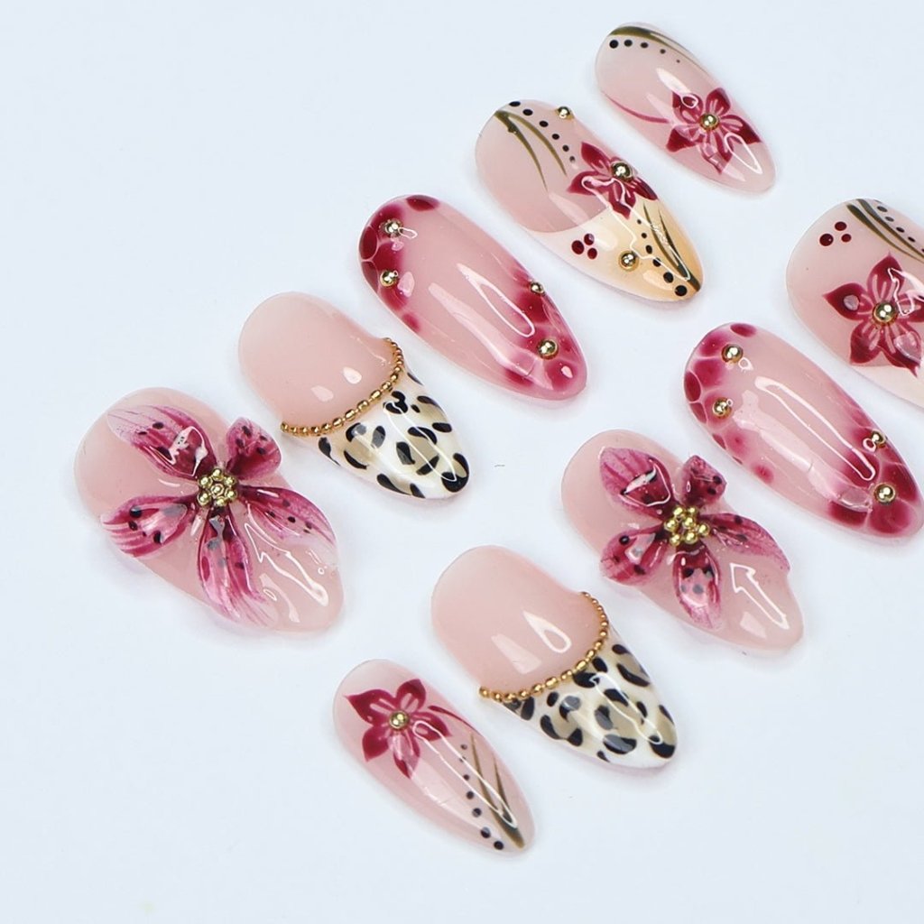 Handmade spring press-on nails featuring delicate 3D sakura flowers, leopard print French tips, and gold accents. Designed in a soft pink color palette with a glossy finish, perfect for floral nail lovers, holiday nails, vacation-ready nails, and birthday nail sets.