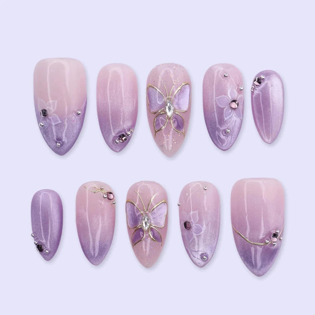 3D lavender ombré press on nails with gold butterfly motif, embellished with white floral accents and crystals — custom press on nails, luxury handmade nail art, fake nails, false nails, pressons — perfect for prom, spring events, and fairy-tale aesthetics